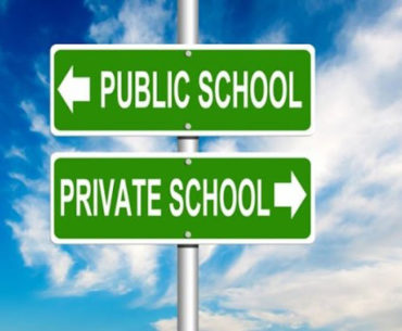 Road sign with signs for public school and private school